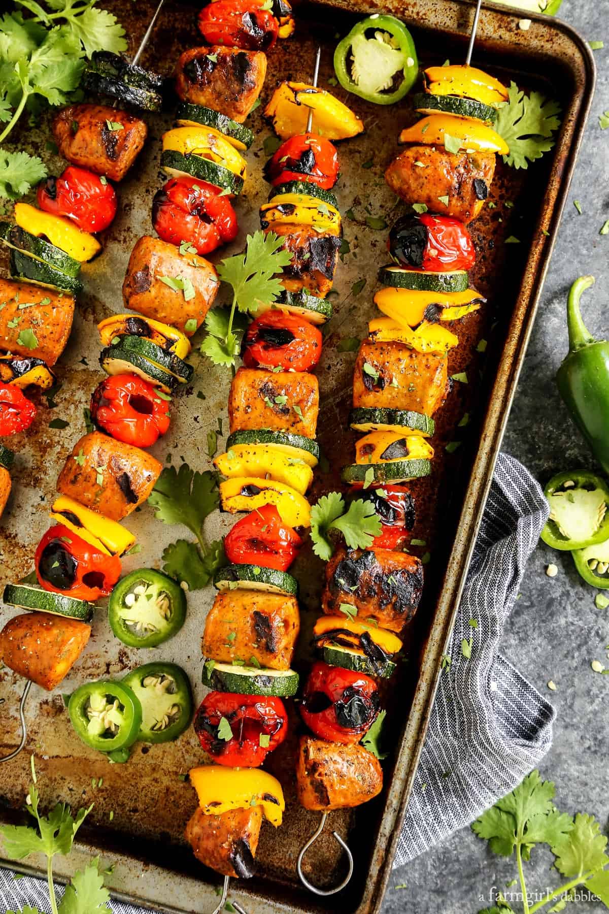 Grilled Jalapeno Cheddar Chicken Sausage Kebabs with Peppadews on a sheet pan