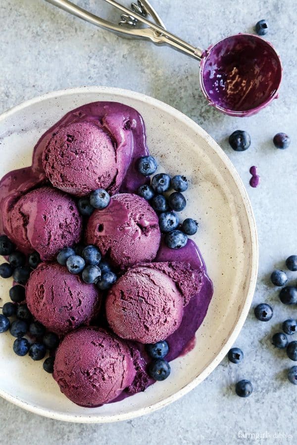 scoops of Roasted Blueberry Crème Fraîche Ice Cream on a white plate