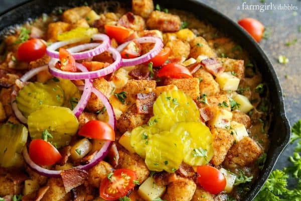 Bacon Cheeseburger Tater Tot Hotdish with sliced pickles and onions