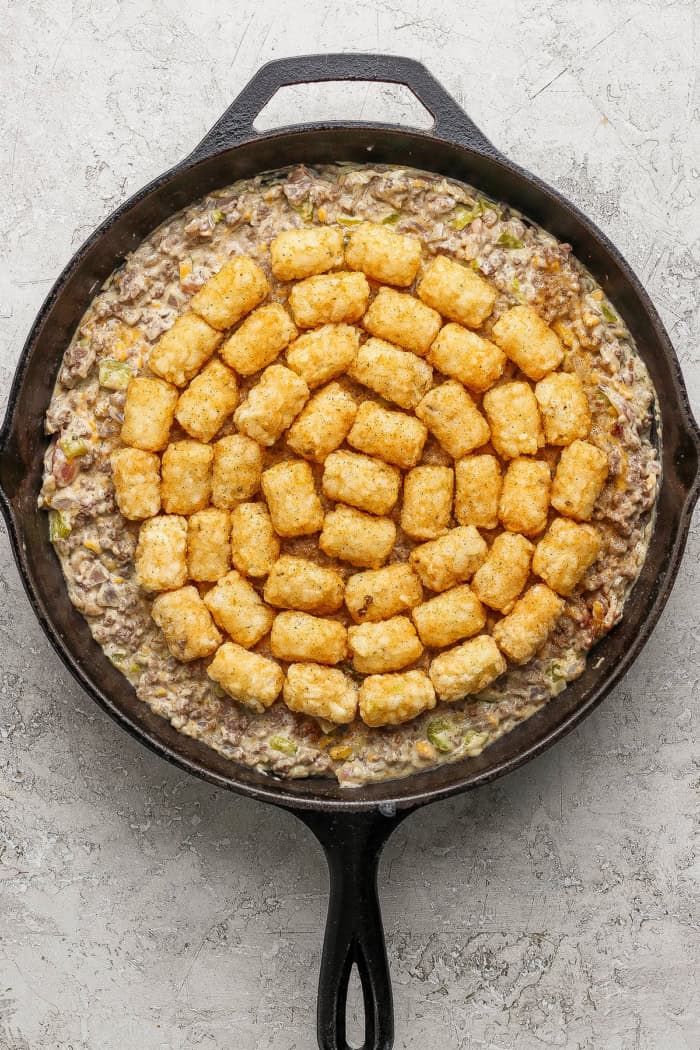 Bacon cheeseburger casserole in skillet before baking.