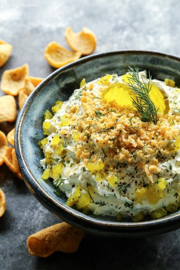 Creamy dill pickle dip topped with diced dill pickles and cracker crumbs