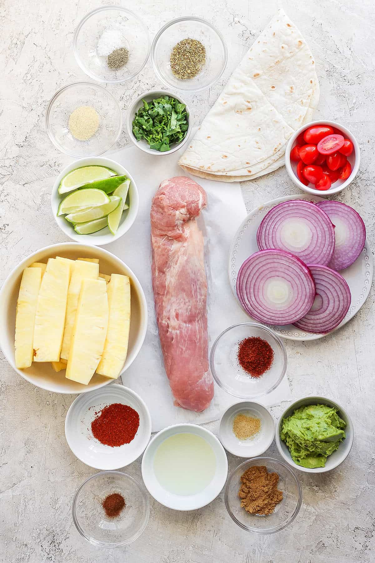 Overhead view of ingredients for grilled pork and pineapple tacos
