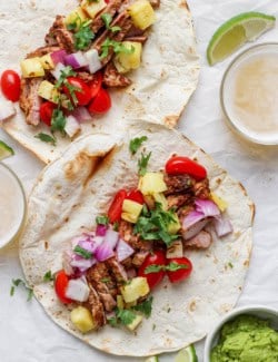 Two pulled pork and pineapple tacos before folding