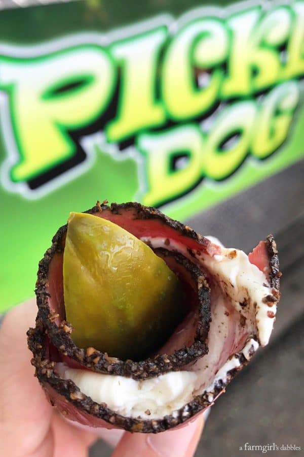 a dill pickle spear wrapped in pastrami and cream cheese