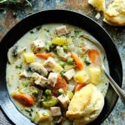 Smoked Turkey Pot Pie Soup in a pottery bowl with fresh biscuits