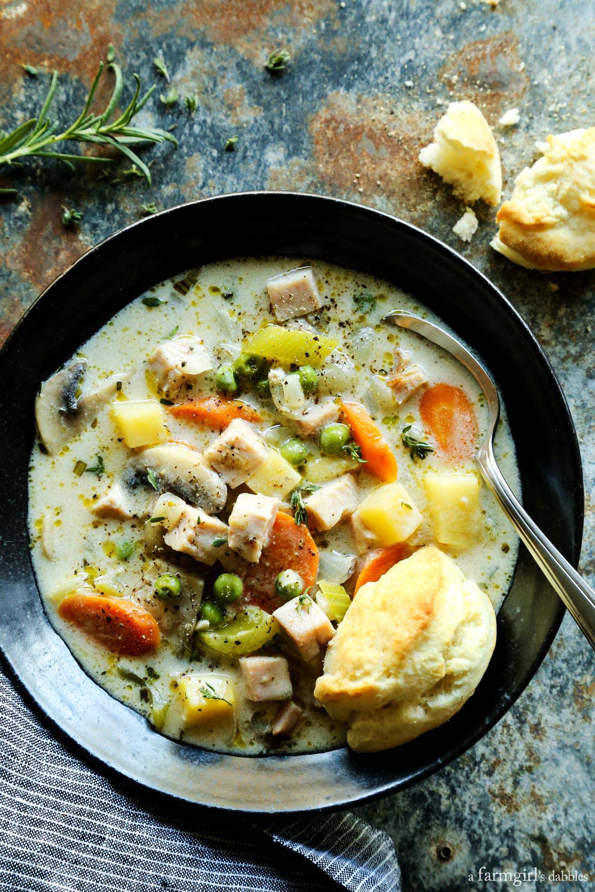 Smoked Turkey Pot Pie Soup in a pottery bowl with fresh biscuits