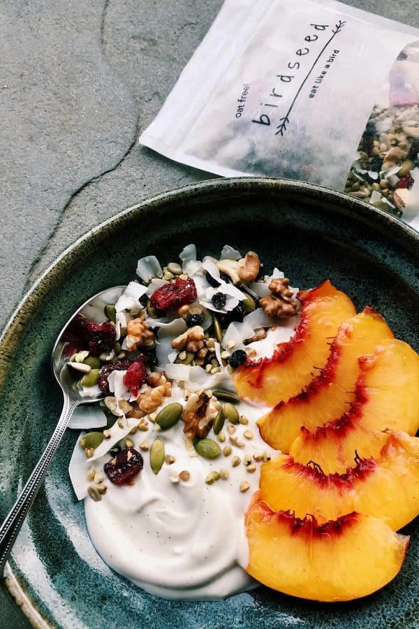 yogurt with granola and fresh peach slices