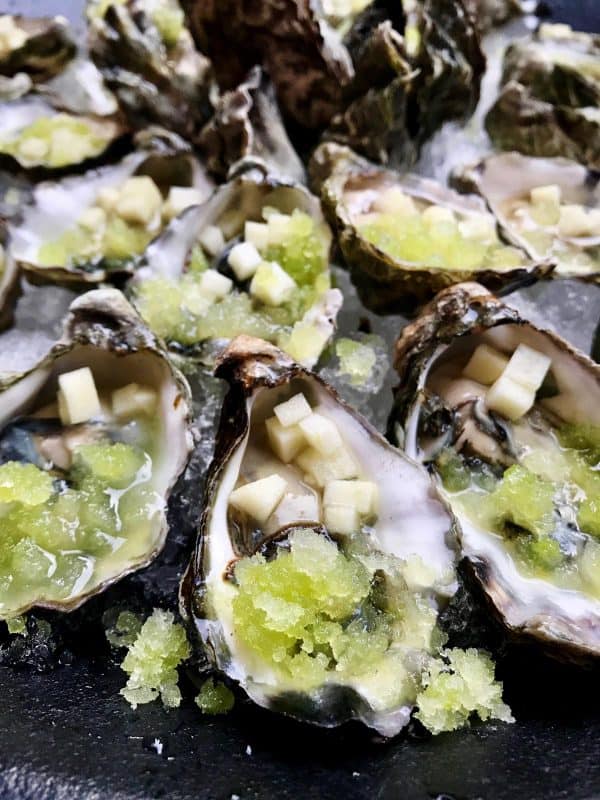 a plate of fresh oysters on ice