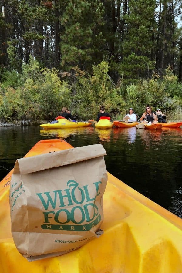 a Whole Food paper bag on a kayak