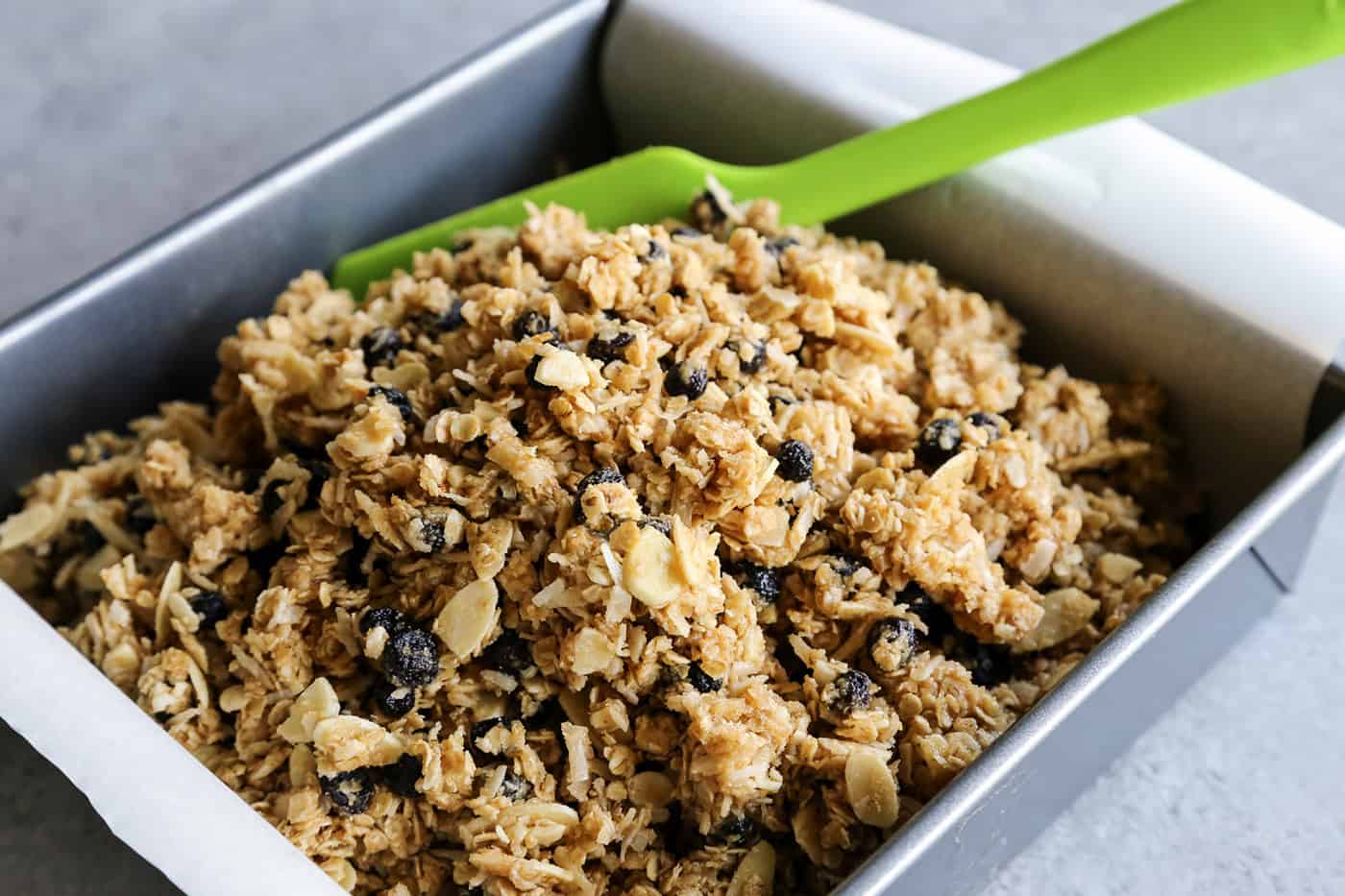 Mixing granola bar ingredients in a baking dish