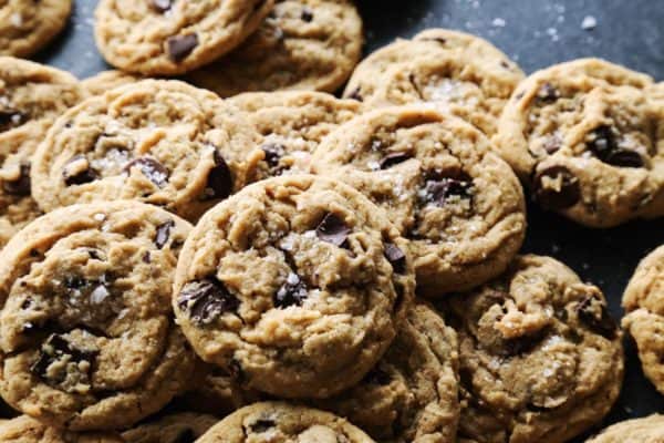 a pile of peanut butter chocolate chip cookies on a counter