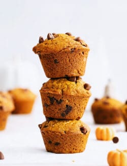 Three pumpkin chocolate chip muffins stacked on each other