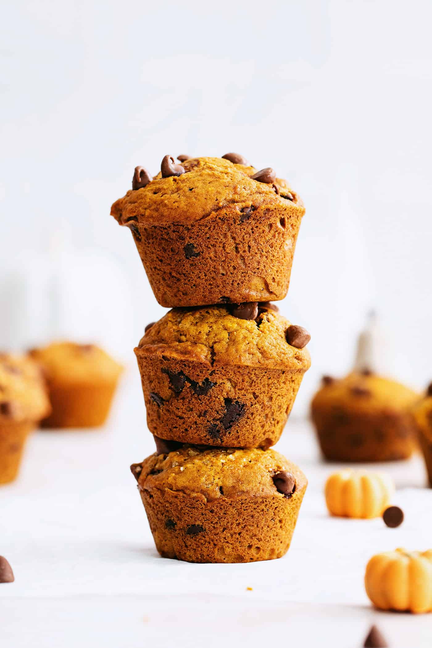 Three pumpkin chocolate chip muffins stacked on each other