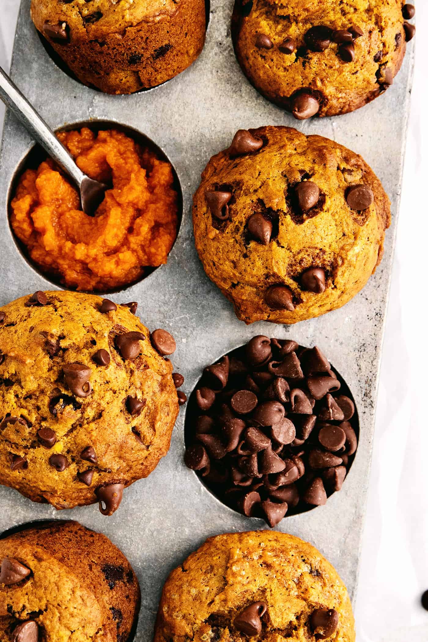 Overhead view of pumpkin muffins in a muffin pan