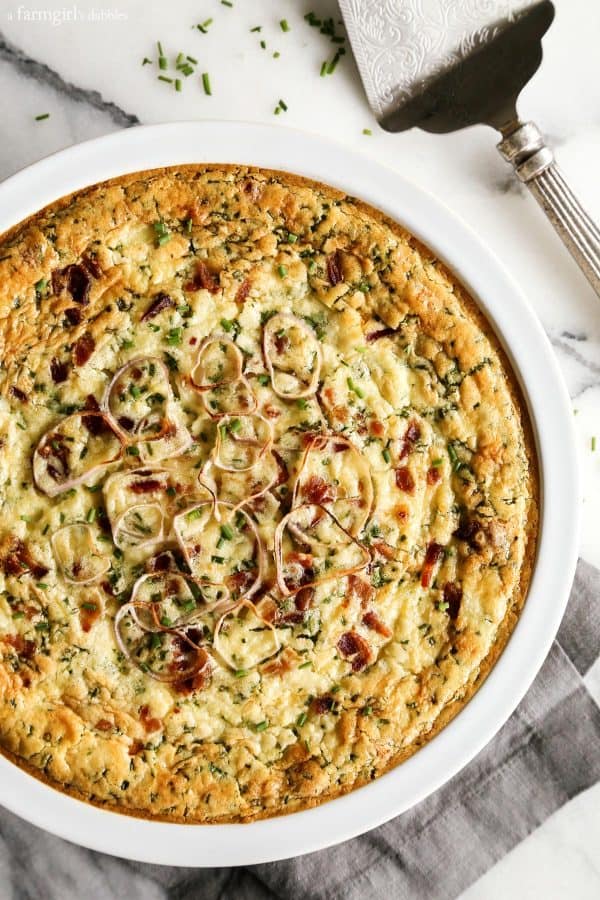 Herby Crustless Quiche with Crab and Bacon in a white dish