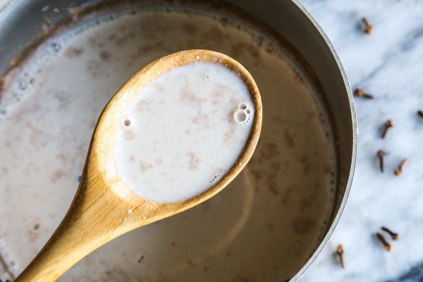 spices in the homemade eggnog, shown in a saucepan