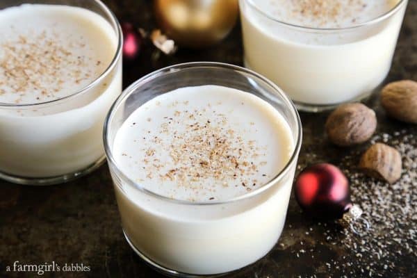 Homemade Eggnog with nutmeg and christmas ornaments