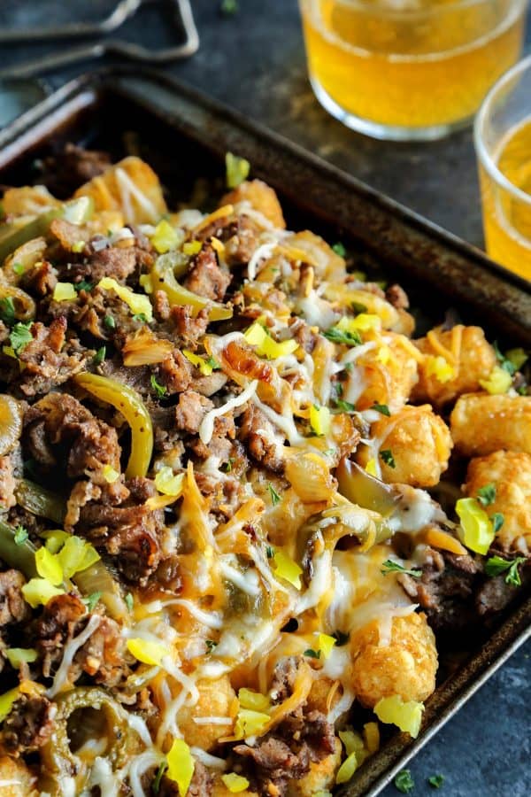 Cheesesteak Totchos on a rimmed baking pan