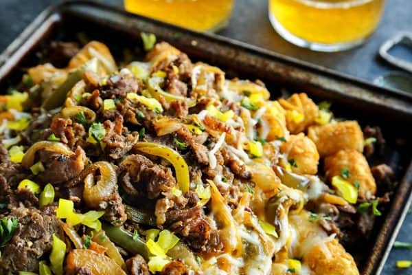 Cheesesteak Totchos on a rimmed baking sheet