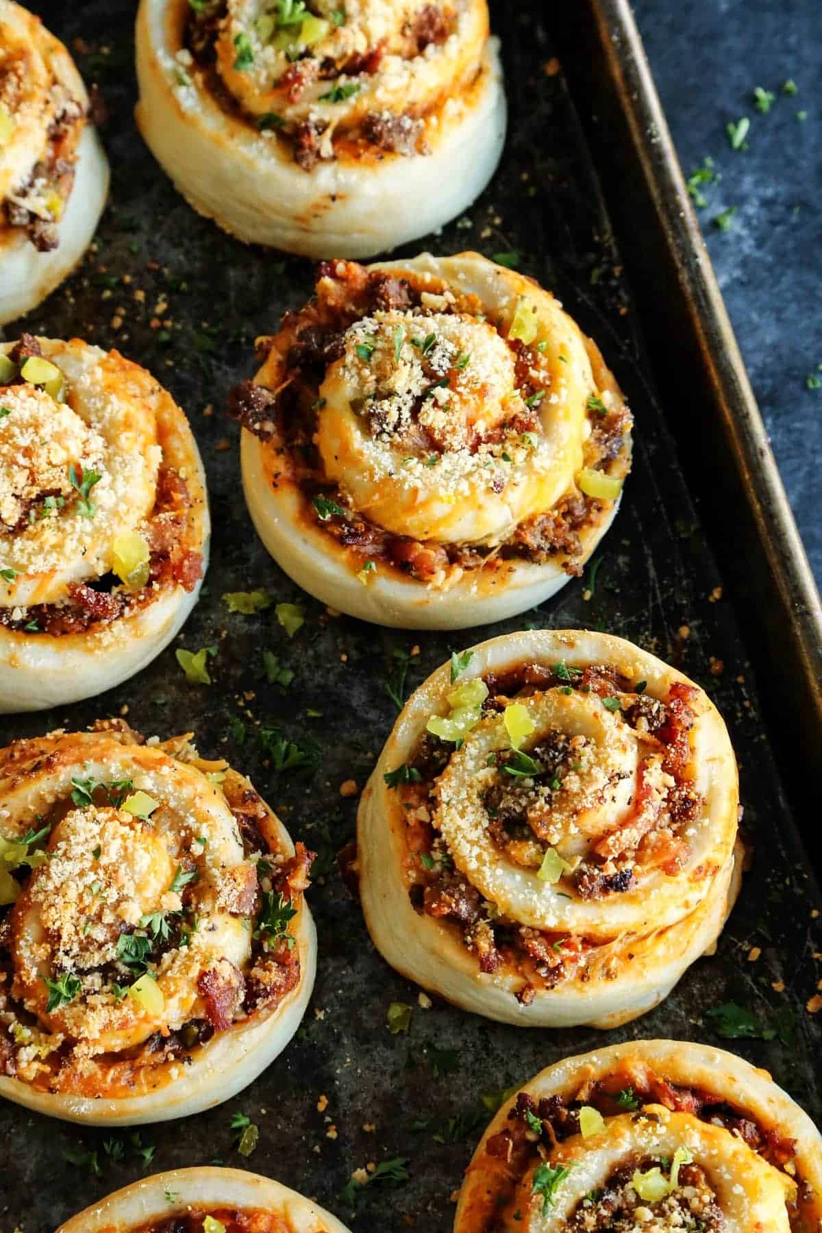 Bacon Cheeseburger Pizza Rolls on a rimmed baking sheet