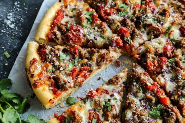 Skillet Pizza with Sausage and Chili Garlic Tomato Sauce cut into slices