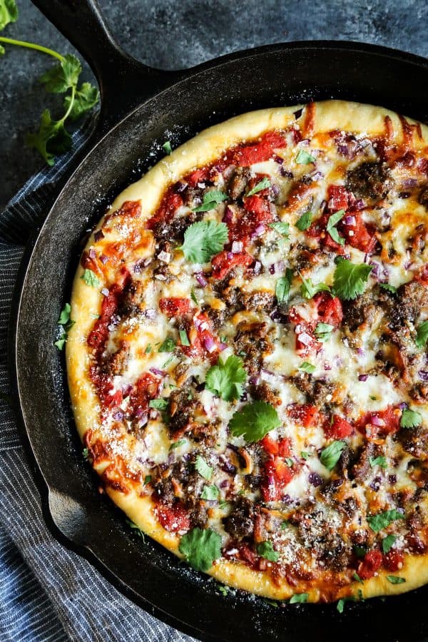 Skillet Pizza with Sausage and Chili Garlic Tomato Sauce with fresh cilantro