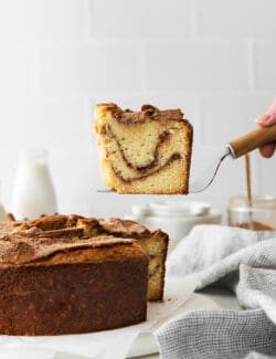 A spatula serving a slice of sour cream coffee cake with cinnamon ripple