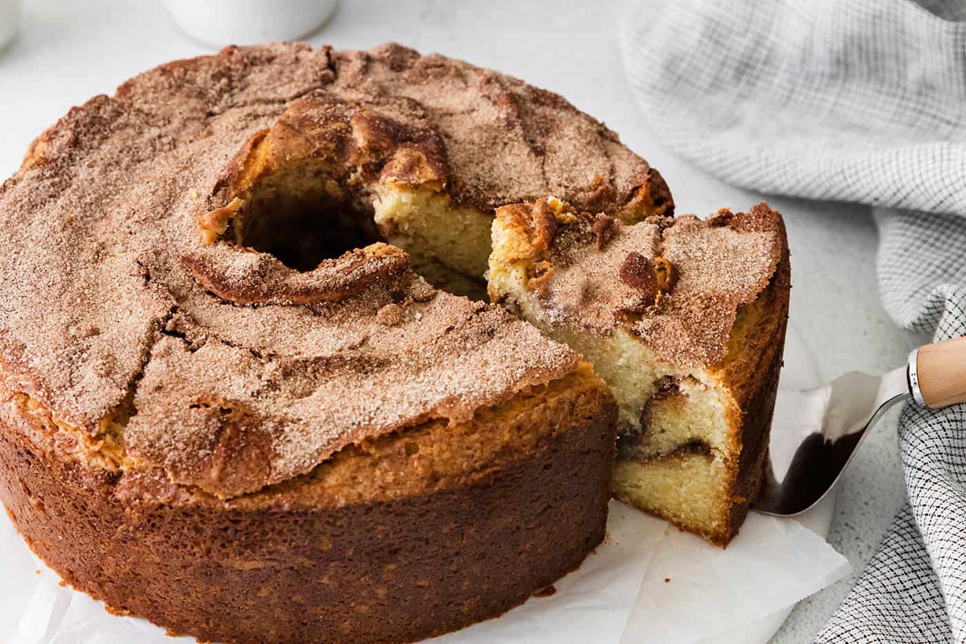 A slice being served from a sour cream coffee cake