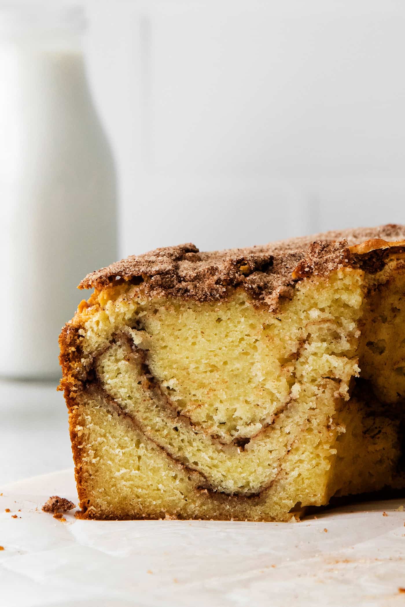 A slice of sour cream coffee cake with cinnamon swirl