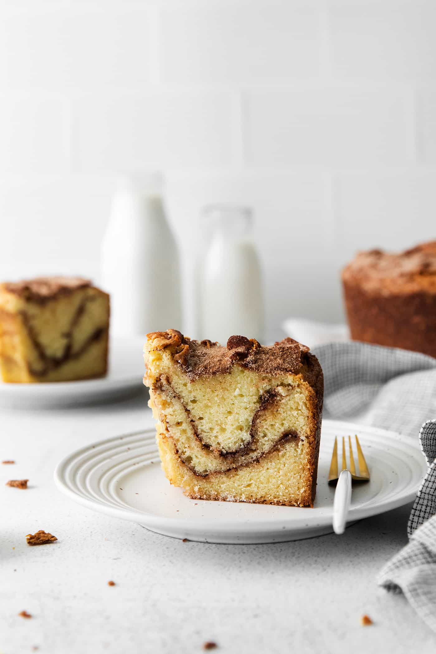 A slice of cinnamon sour cream coffee cake on a plate