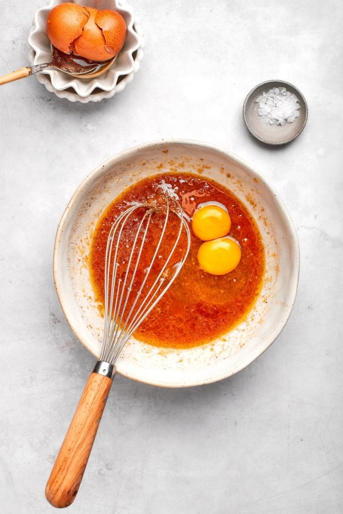 Whisking egg yolks into wet ingredients for skillet cookie.