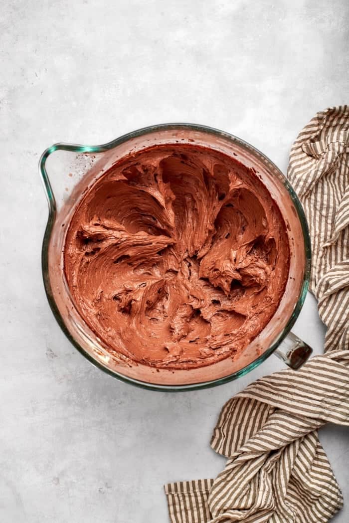 Chocolate buttercream in glass mixing bowl.