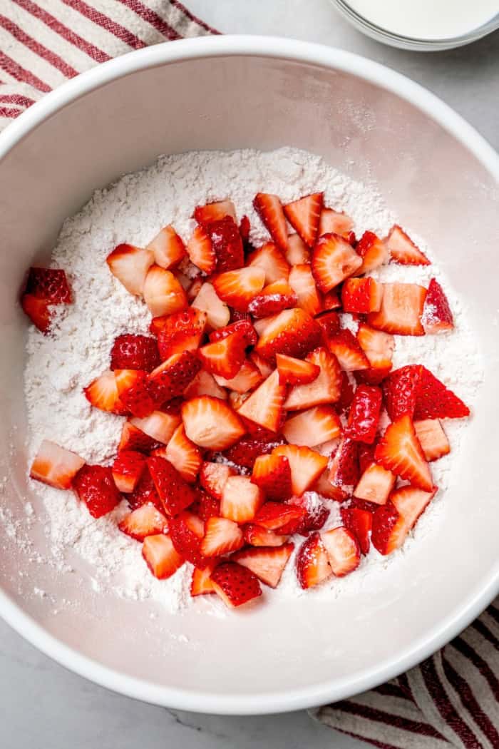 Overhead view of strawberries added to dough mixture for scones