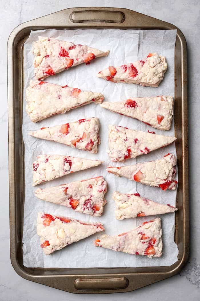 Overhead view of strawberry scones on baking sheet