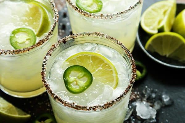 Jalapeno Mezcal Margaritas. with fresh lime wedges