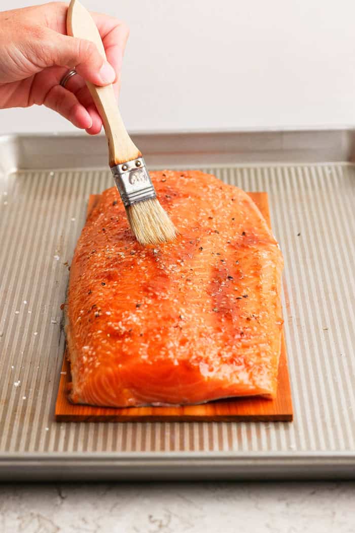 Grilled Chipotle-Orange Salmon is sweet, smoky and just a bit spicy, with irresistible caramelized edges. An easy recipe that feels special! Brushing glaze mixture over salmon fillet