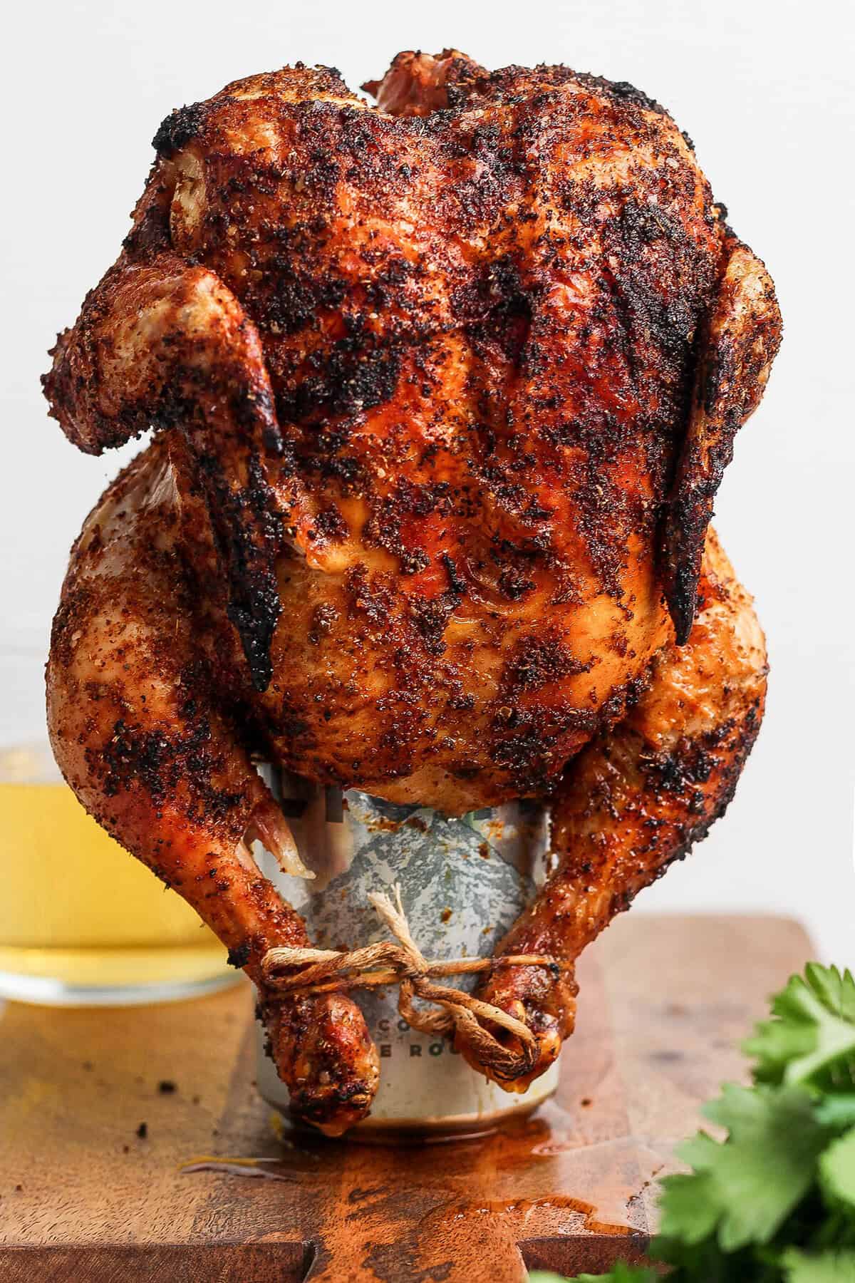 Cooked beer can chicken standing on can