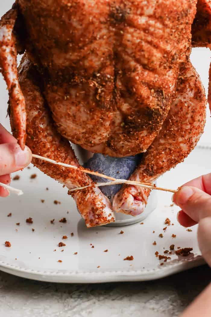 Tying chicken legs to secure it on beer can
