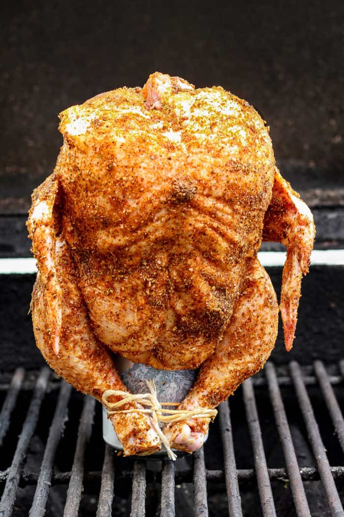 Beer can chicken standing on can set on grill