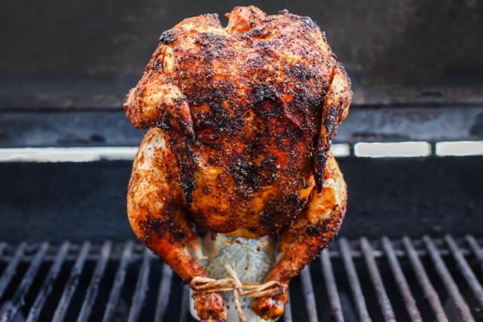 Cooked beer can chicken standing on can set on grill