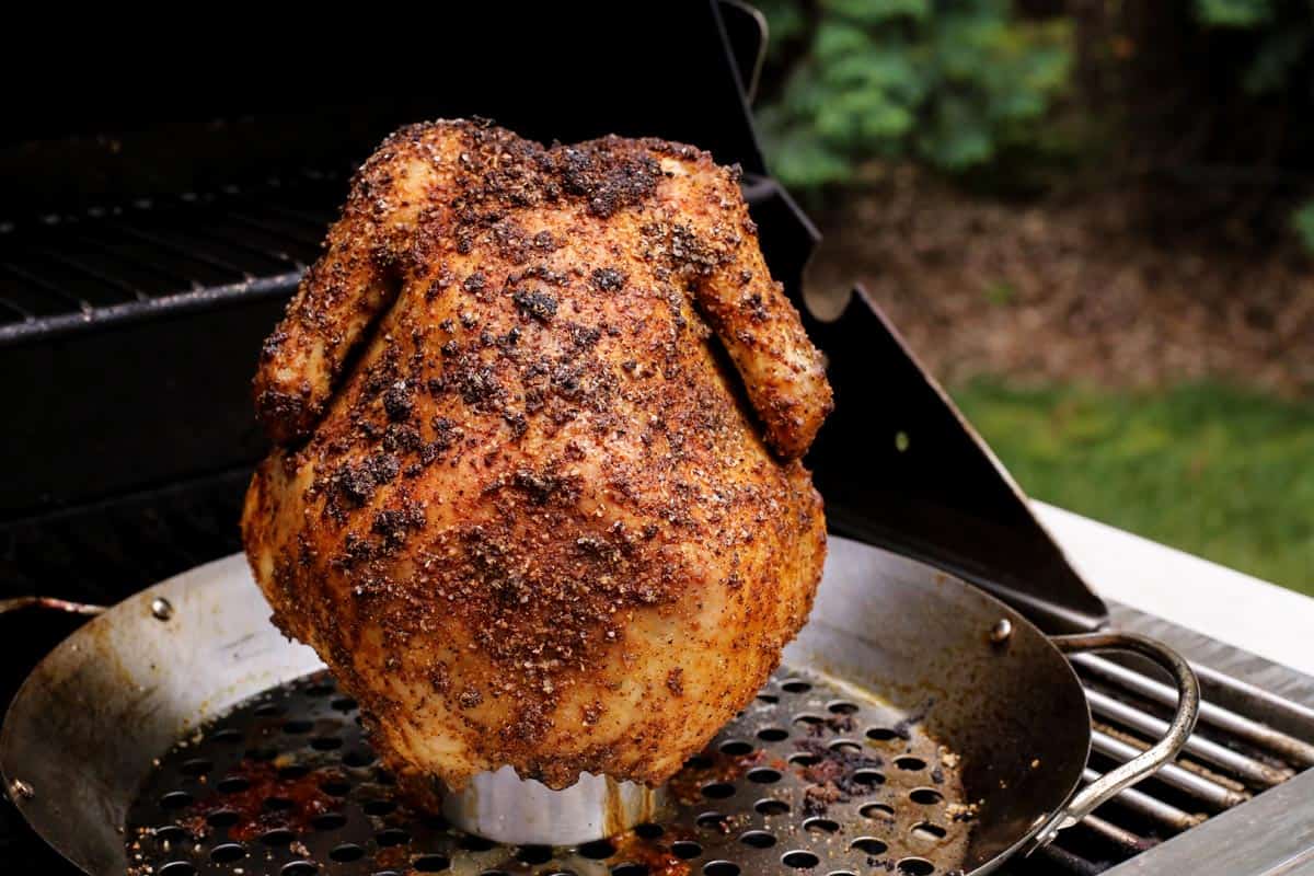 a whole chicken, rubbed with seasoning, grilled on a beer can