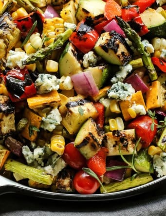 Closeup of grilled vegetable salad with crumbled blue cheese
