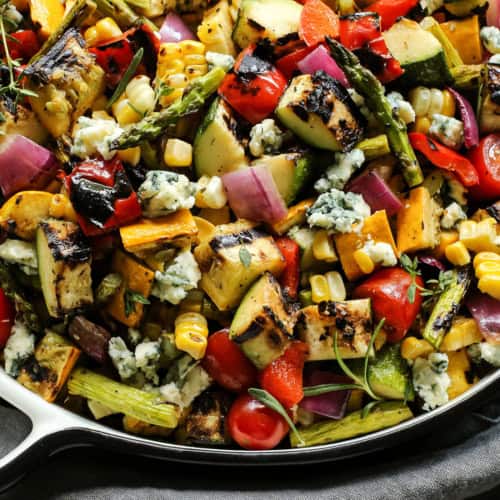 Closeup of grilled vegetable salad with crumbled blue cheese