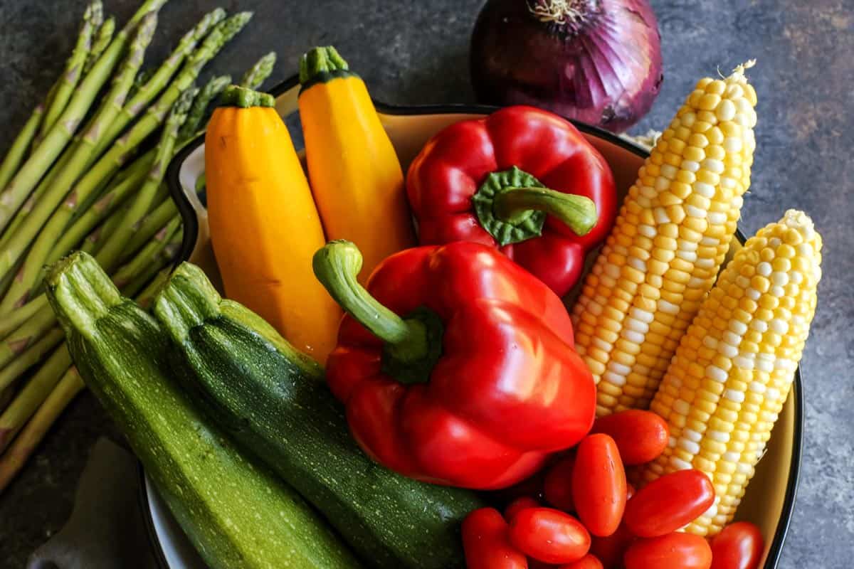 asparagus, zucchini, yellow squash, red peppers, red onion, sweet corn, and grape tomatoes