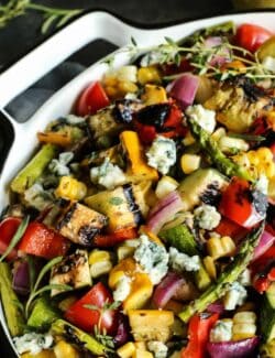 grilled vegetable salad in a large white bowl