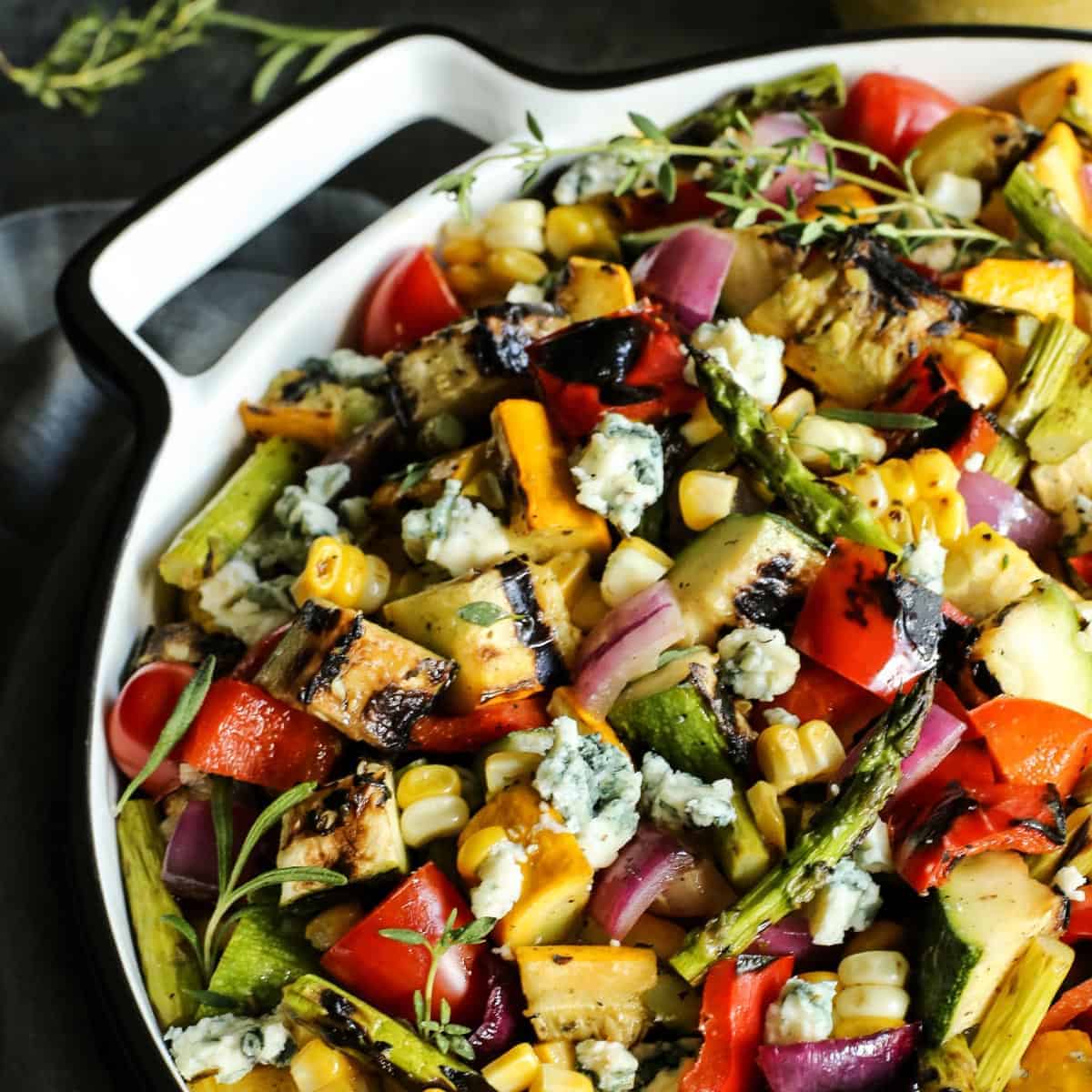 grilled vegetable salad in a large white bowl