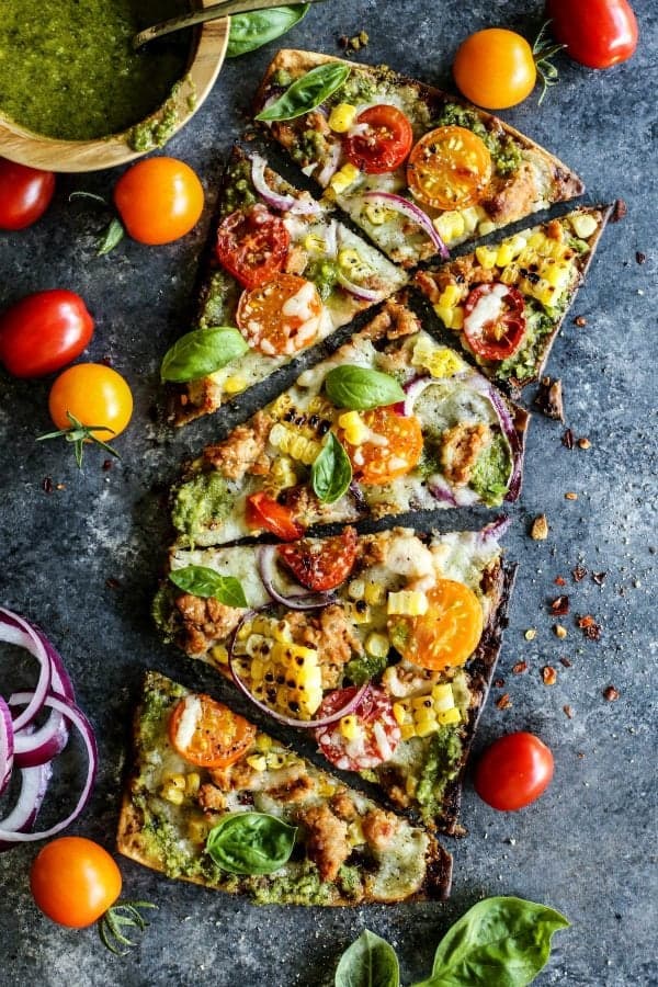 a pizza with a flatbread crust, grilled and cut into random shaped pieces