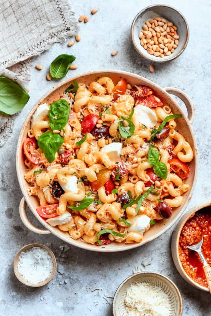 This sun-dried tomato pasta salad lets the abundance of summer produce shine, with juicy tomatoes and fresh basil. Perfect for picnics! Bowl of sun-dried tomato pasta salad.