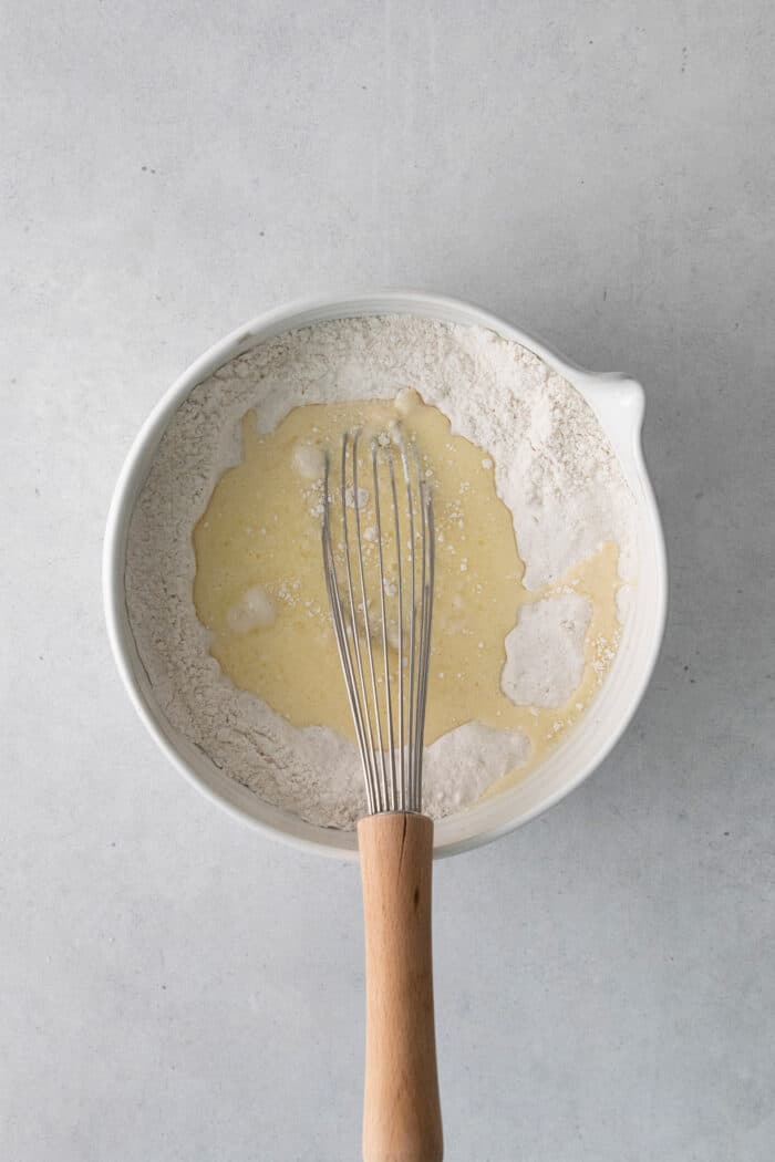 A whisk combining muffin ingredients