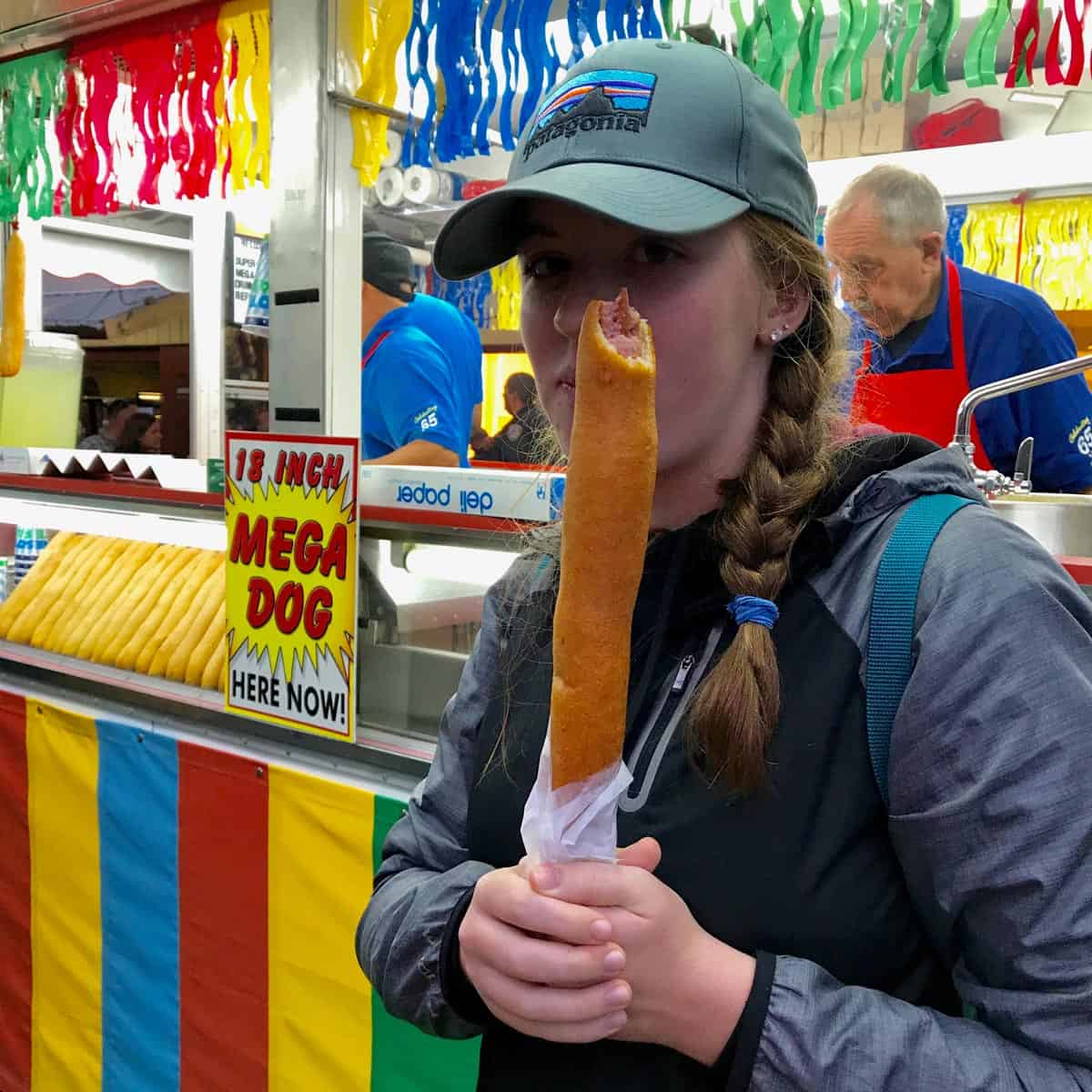 girl holding foot long corndog 